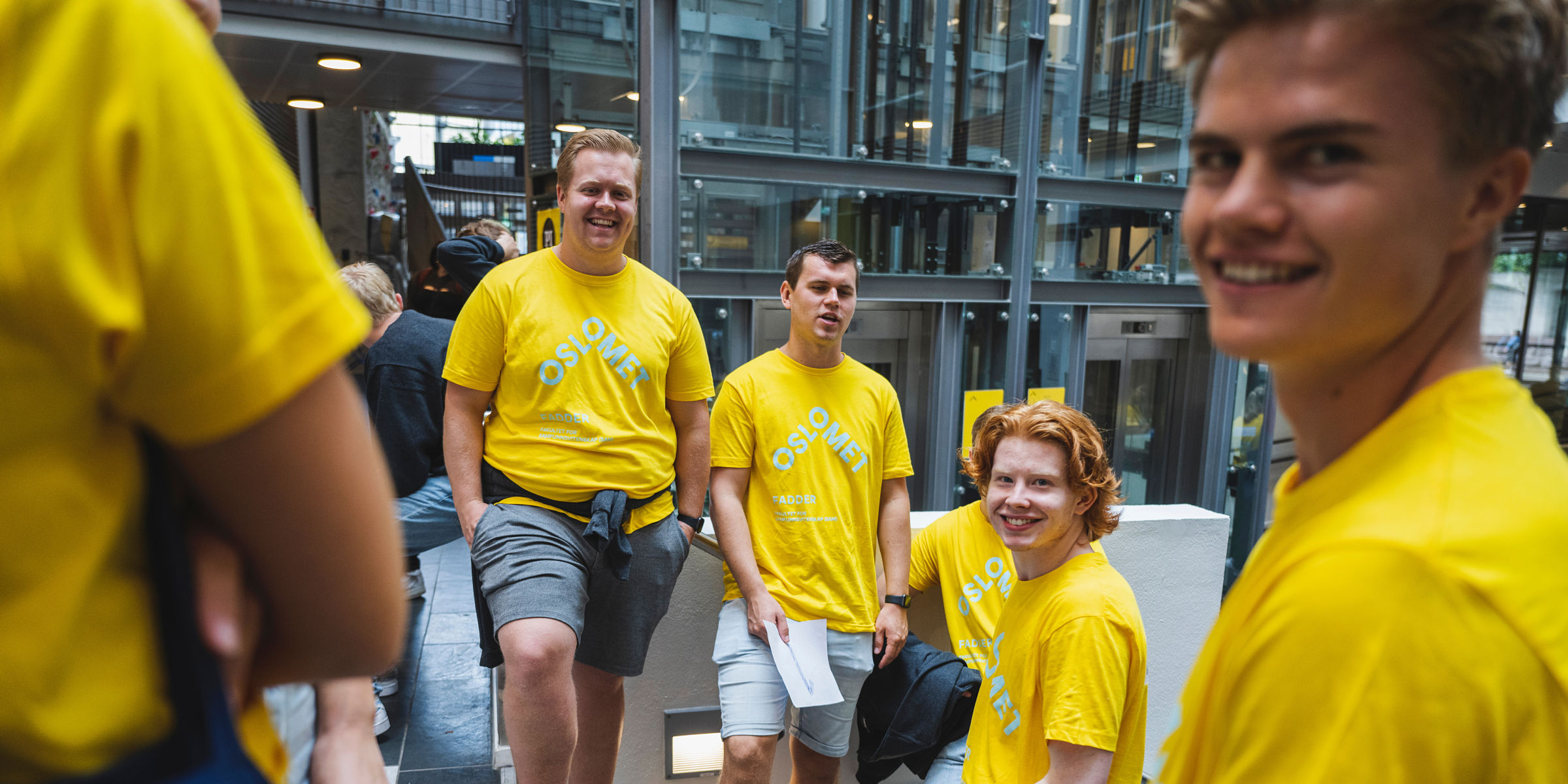 Buddies with yellow t-shirts looks into the camera.